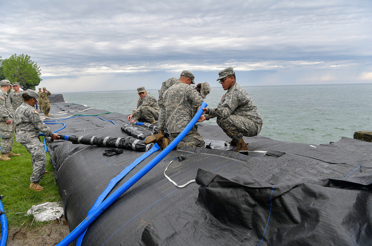 U.S. Army Soldiers Placing Inflatable Dam Along Lake Ontario